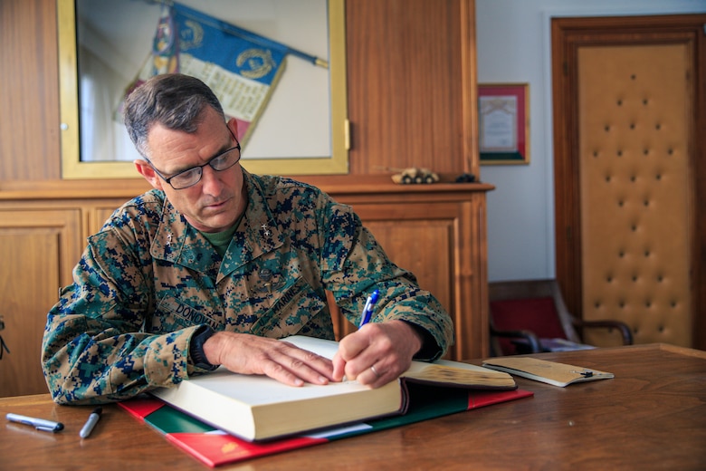 U.S. Marine Corps Maj. Gen. Francis Donovan, commanding general, 2d Marine Division, signs the guest book for the 1st Foreign Cavalry Regiment, 6th Light Armoured Brigade, in Compiegne, France, June 2, 2021. Donovan’s visit to France included engagements with key leaders to strengthen relationships with the French Armed Forces in order to refine interoperability for future cooperation. (U.S. Marine Corps photo by Sgt. Margaret Gale)