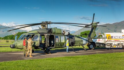 U.S. Army Chief Warrant Officer 3 Mauricio Garcia, and his Colombian safety officer counterpart, Capt. Cristian Castiblanco, walk the flight line of Tolemaida Army Base inspecting for safety hazards and violations. Garcia, a UH-60M Black Hawk pilot and aviation safety officer, is deployed here as part of a technical advising team from U.S. Army Security Assistance Command’s Fort Bragg-based training unit, the Security Assistance Training Management Organization. (photo by Richard Bumgardner)