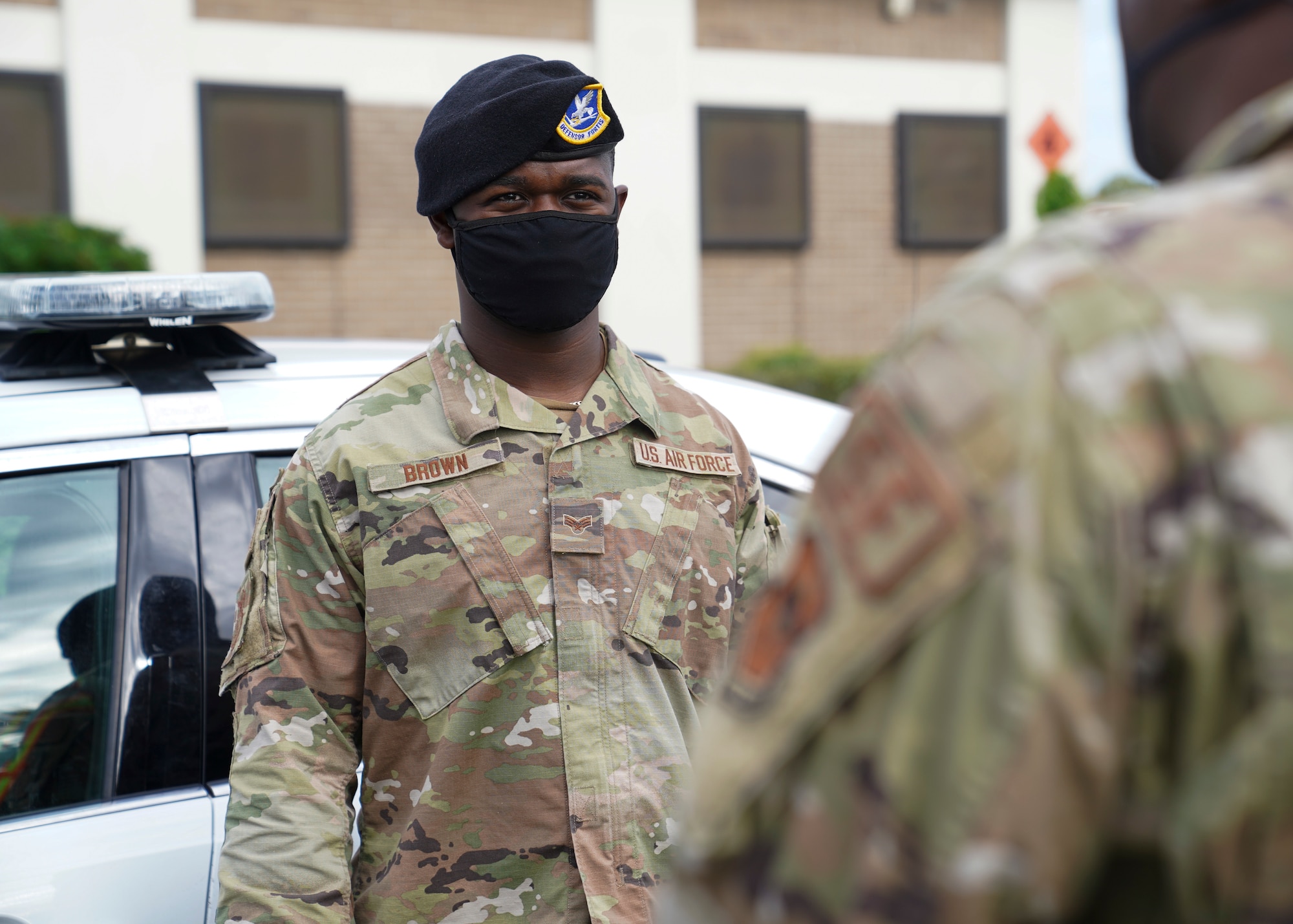 U.S. Air Force Senior Airman Leonard Brown, 81st Security Forces Squadron NCOIC of police services, talks to Airman 1st Class Grady Adams, 81 SFS patrolman, outside the security forces building at Keesler Air Force Base, Mississippi, June 7, 2021. The 81st SFS is responsible for making sure the base populace is safe at all times. (U.S. Air Force photo by Senior Airman Spencer Tobler)