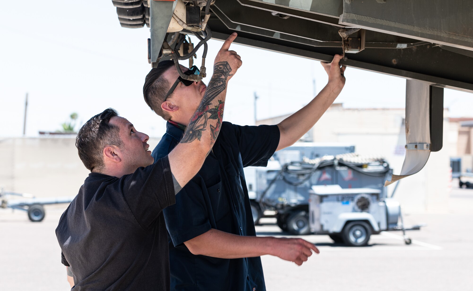 Daniel Villela (left) and Staff Sgt. Daniel Ward, 56th Logistics Readiness Squadron vehicle management technicians, work at the 56th LRS Rapid Maintenance Annex May 17, 2021, at Luke Air Force Base, Arizona.