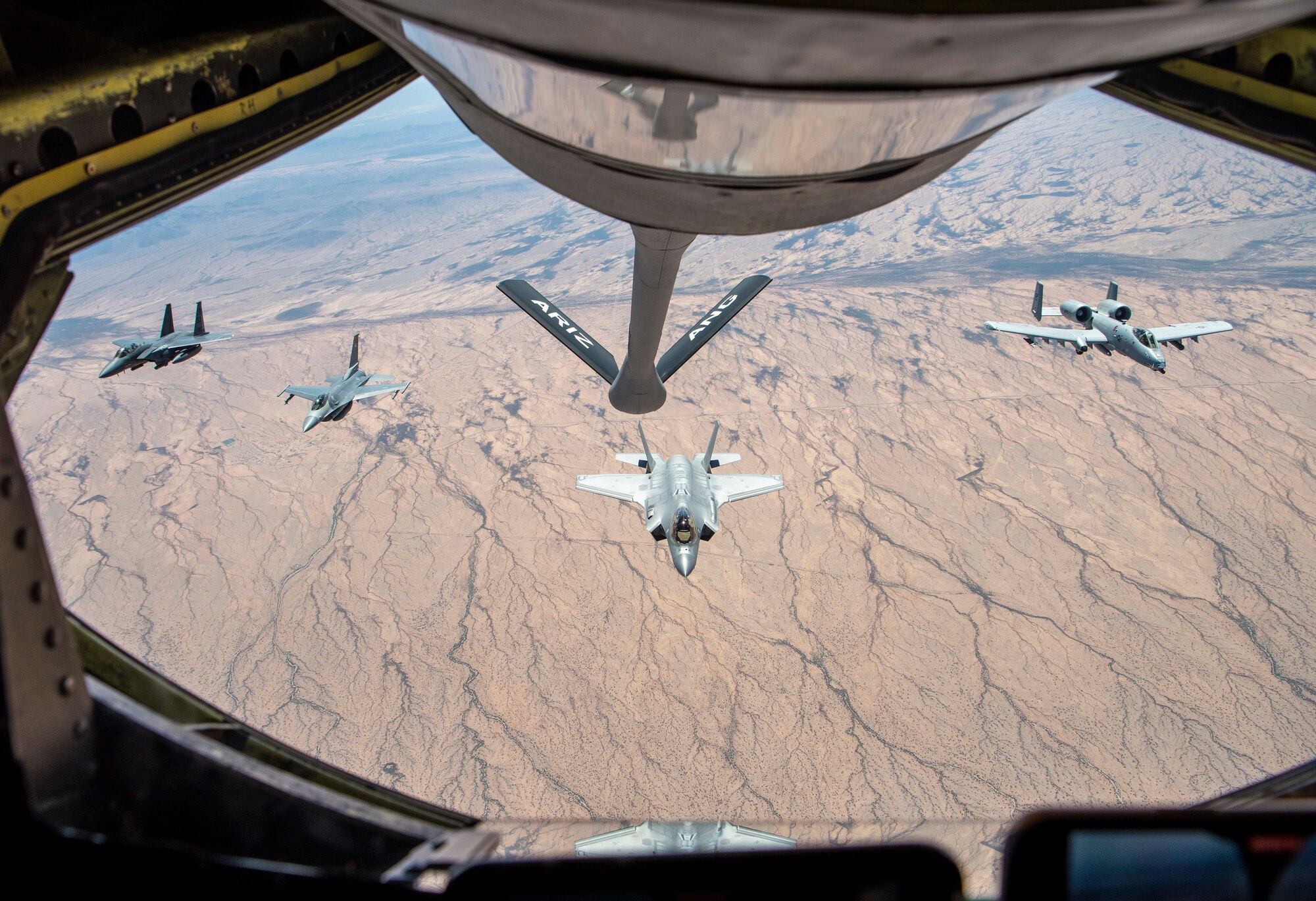 An F-15E Strike Eagle, F-16 Fighting Falcon, F-35 Lightning II, and an A-10 Thunderbolt II fly in a four-ship formation over Arizona after being refueled by an Arizona Air National Guard KC-135 Stratotanker from the 161st Air Refueling Wing, June 3, 2021. The 944th Fighter Wing is unique in the fact that they train pilots on four different airframes, with two of them being geographically separated from the unit. The F-15E is out of Seymour Johnson Air Force Base, N.C., and the A-10 belongs to the 924th Fighter Group at Davis-Monthan Air Force Base, Ariz.