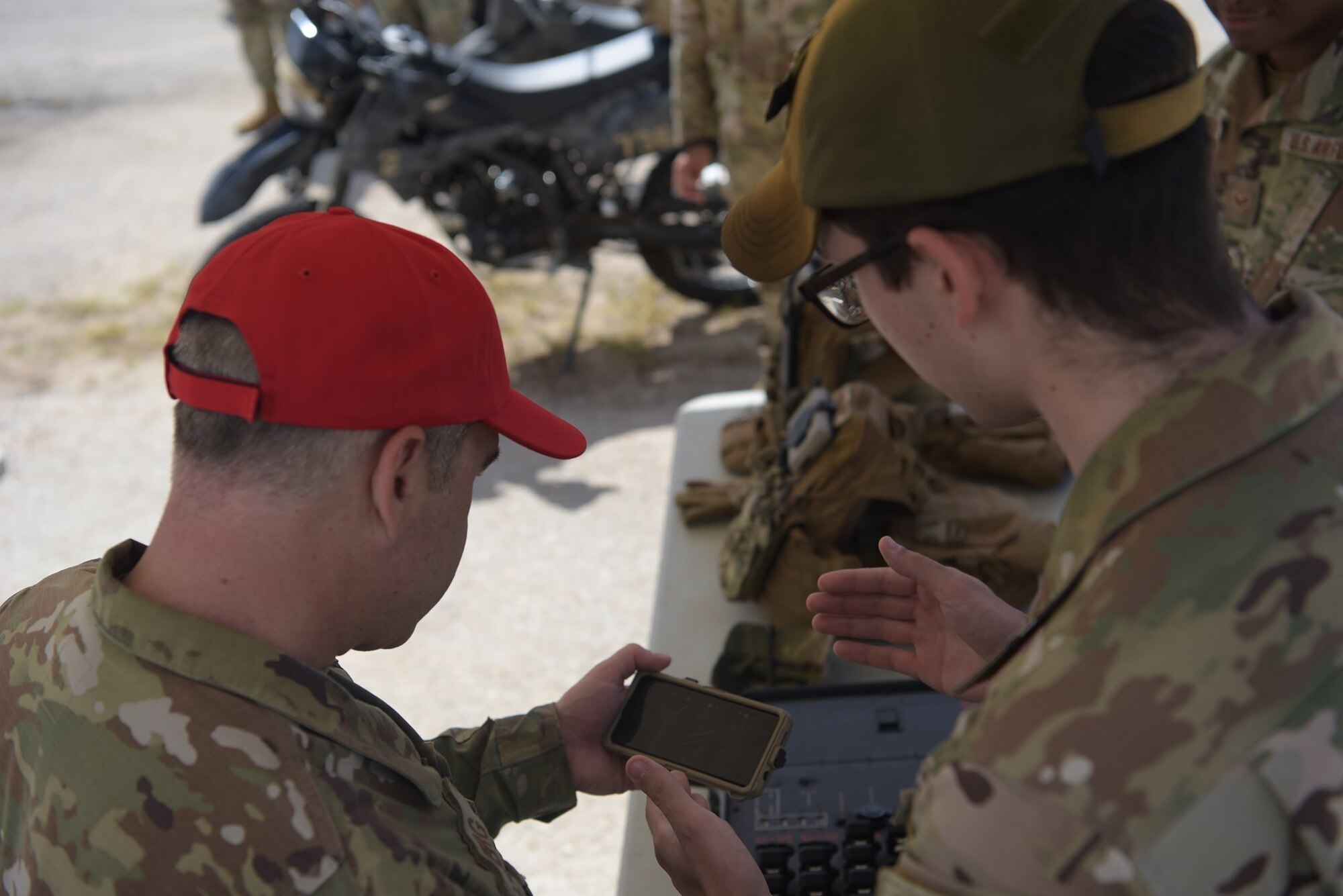 U.S. Air Force Chief Master Sgt. Kristopher Berg, 11th Air Force Command Chief, recieves a brief on the capabilities of the Android Team Awareness Kit from Senior Airman Jonathan Gilbreath, a fire team member assigned to the 736th Security Forces Squadron, June 7, 2021, at Andersen Air Force Base, Guam.