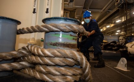 Seaman Eulalio Mesa, from Littlefield, Texas, handles line in the fo'c'sle of the Nimitz-class aircraft carrier USS Harry S. Truman (CVN 75) during Tailored Ship's Training Availability (TSTA) and Final Evaluation Problem (FEP).