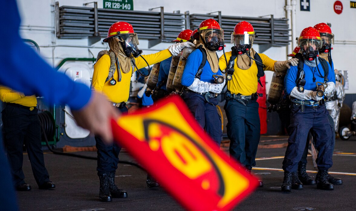 Sailors fight a simulated aircraft fire in the hangar bay of the Nimitz-class aircraft carrier USS Harry S. Truman (CVN 75), during Tailored Ship's Training Availability (TSTA) and Final Evaluation Problem (FEP).