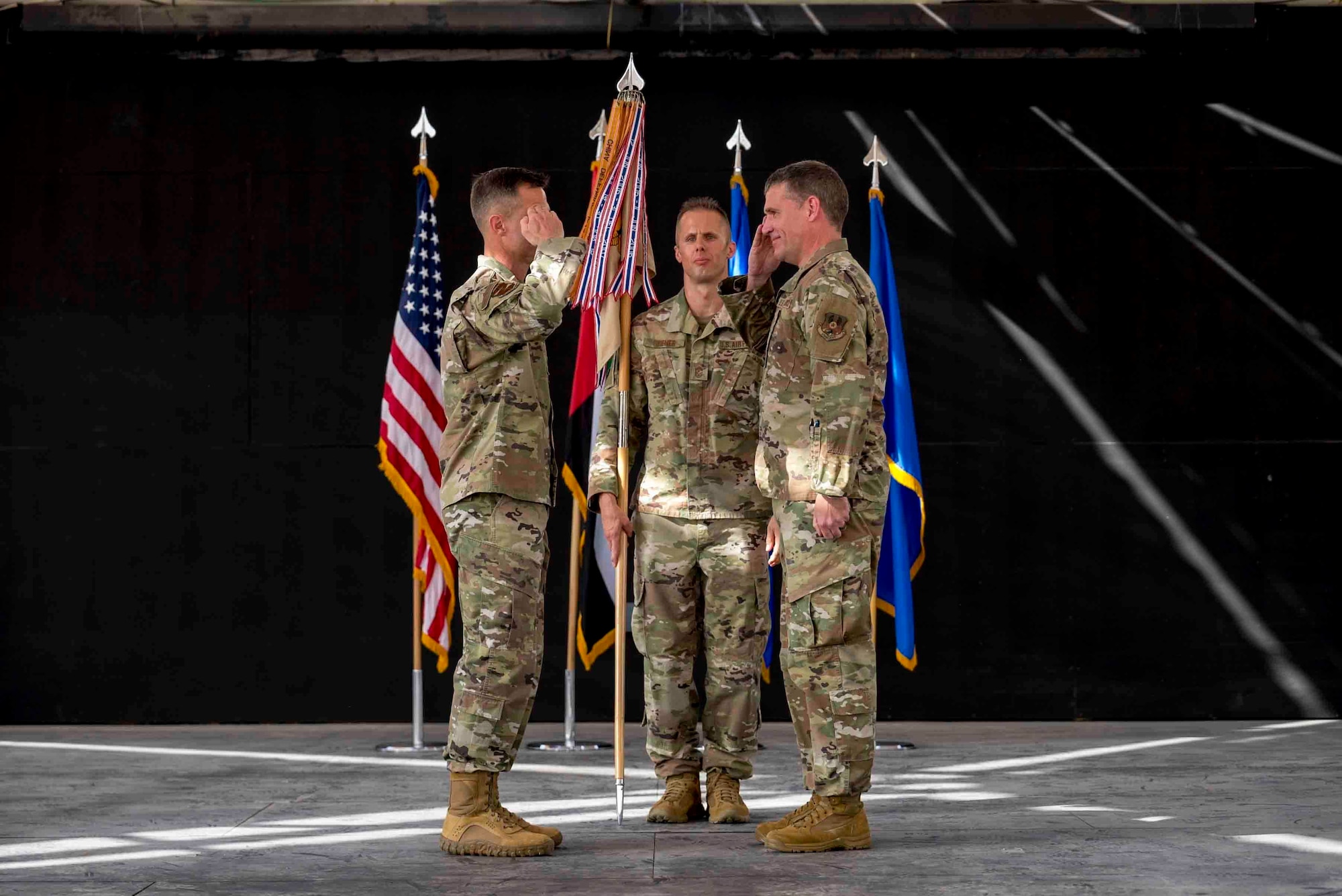 U.S. Air Force Brig. Gen. Larry Broadwell, outgoing commander, passes command of the 380th Air Expeditionary Wing to Brig. Gen. Andrew Clark, incoming commander, during a change of command ceremony at Al Dhafra Air Base, United Arab Emirates, June 8, 2021. The change of command ceremony is a military tradition that represents a formal transfer of authority and responsibility for a unit from one commanding officer to another.