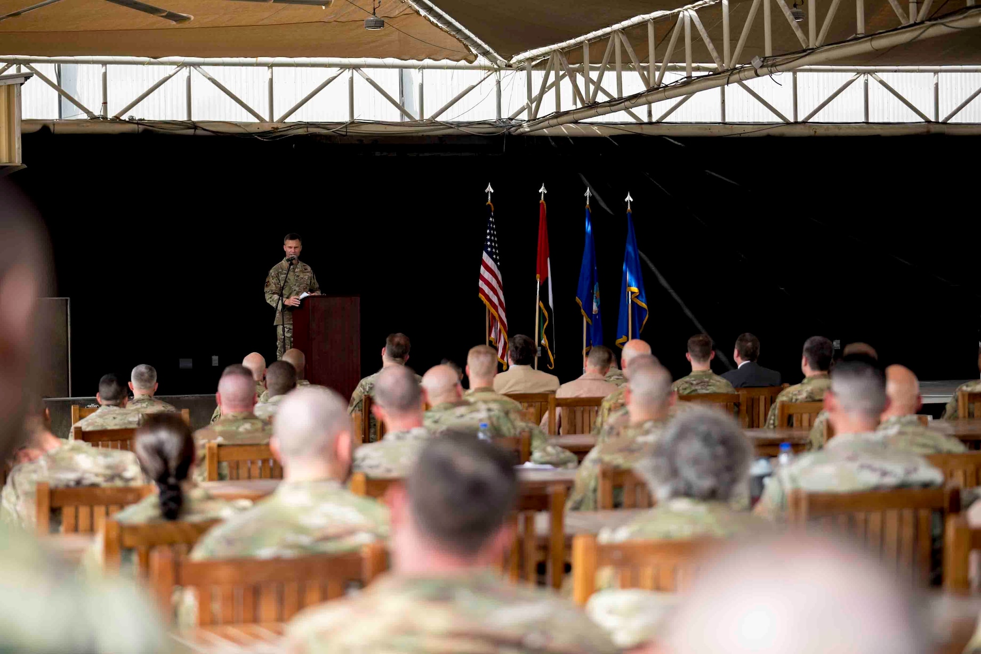 U.S. Air Force Brig. Gen. Larry Broadwell, outgoing commander, passes command of the 380th Air Expeditionary Wing to Brig. Gen. Andrew Clark, incoming commander, during a change of command ceremony at Al Dhafra Air Base, United Arab Emirates, June 8, 2021. The change of command ceremony is a military tradition that represents a formal transfer of authority and responsibility for a unit from one commanding officer to another.