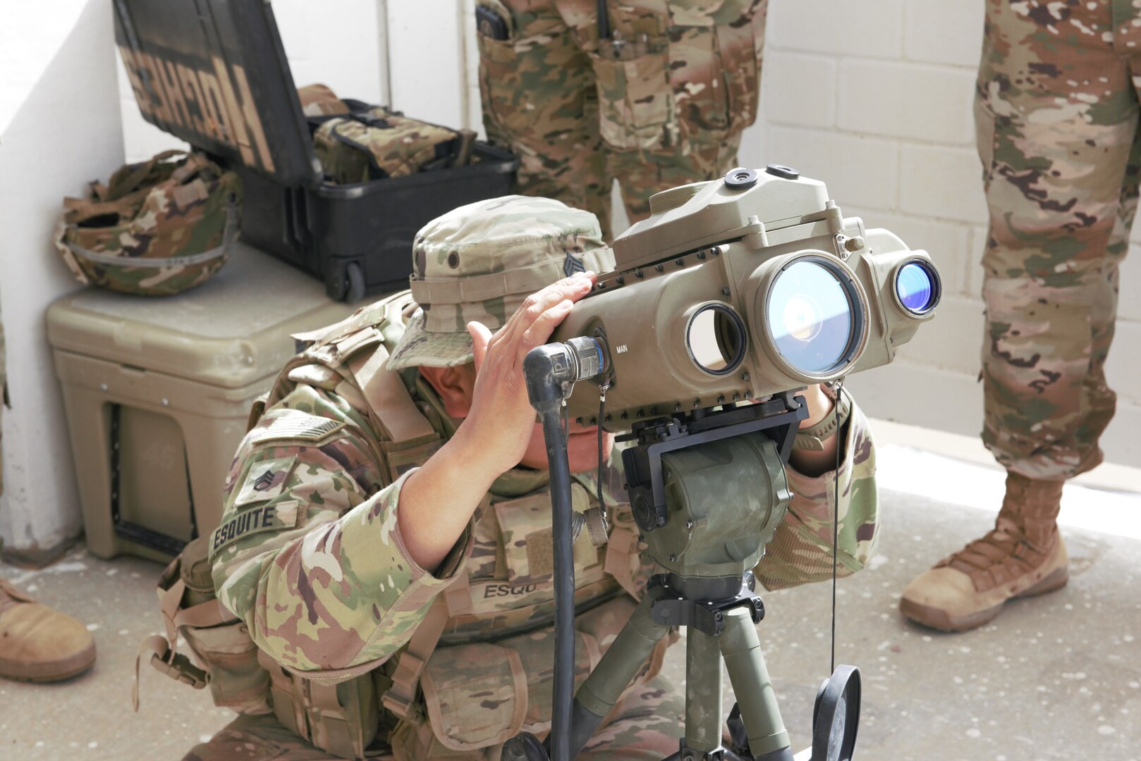 A photo of a Soldier using a lightweight laser designator rangefinder