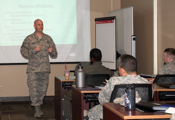 Airmen in front of a classroom speaking to Airmen seated at each desk
