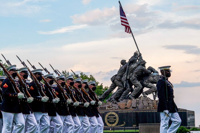Marines with the Silent Drill Platoon march for “Pass in Review” during a Tuesday Sunset Parade at the Marine Corps War Memorial, Arlington, Va., June 8, 2021. The hosting official for the evening was Mr. Robert D. Hogue, counsel for the Commandant of the Marine Corps, and The Honorable Kirsten E. Gillibrand, U.S. Senator for New York, was the guest of honor.