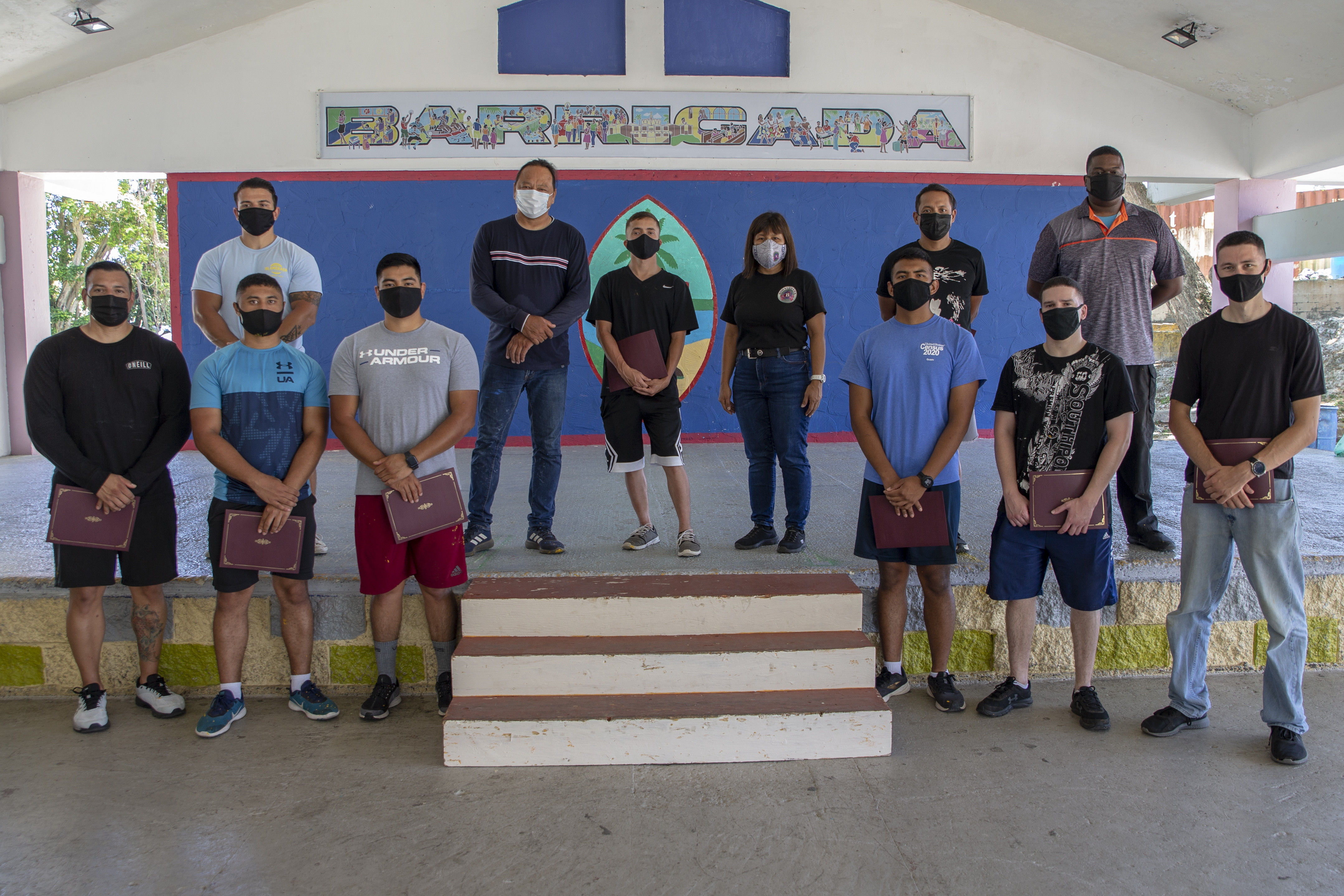 U.S. Marines and civilian personnel assigned to Marine Corps Base (MCB) Camp Blaz pose for a group photo with the Barrigada, Guam Mayor and Vice-Mayor after volunteering with employees of the Barrigada Mayor’s Office in Barrigada, April 8, 2021.