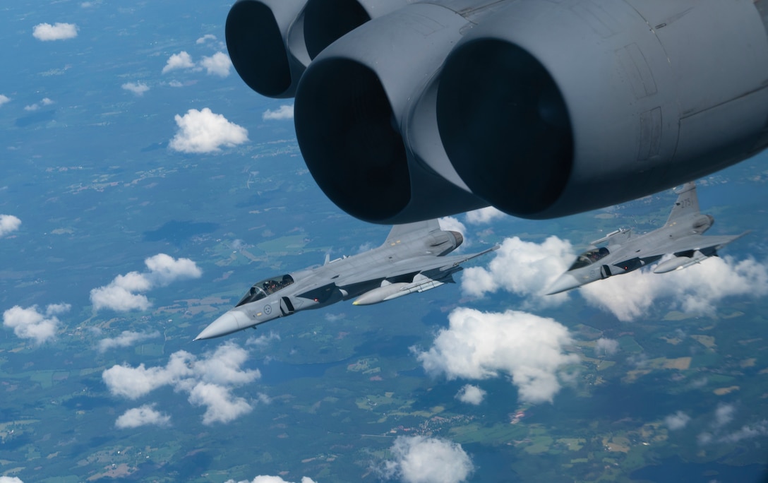 Two Swedish Saab JAS-39 Gripen fighter jets escort a B-52H Stratofortress over Europe during a Bomber Task Force Europe 21-3 flight en route to a maritime training scenario, June 09, 2021.