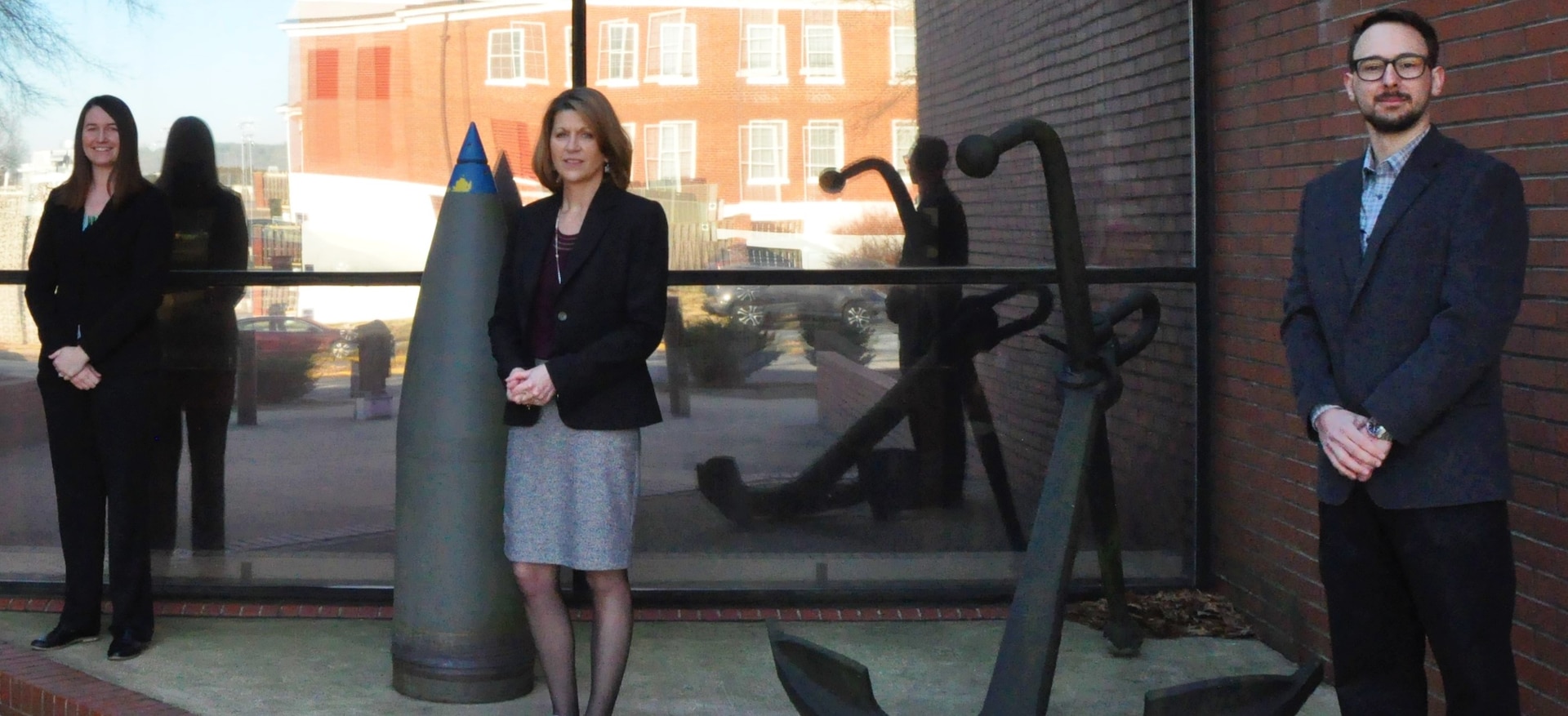 IMAGE: DAHLGREN, Va. – Meagan Parker, Glenna Miller and Graham McConnell are pictured outside Naval Surface Warfare Center Dahlgren Division headquarters. Parker, left, is the Post Intercept Debris Simulation (PIDS) Program’s technical lead. McConnell is the technical lead for the Damaged State Modeling of a Post Intercept Threat Program, also known as Damaged States. Miller is the program manager for both programs. PIDS is designed to provide Department of Defense testbeds with a representation of post-intercept debris for specific missile engagements. The Damaged States Program endeavors to provide the Navy with a new capability to evaluate true weapon system effectiveness during every engagement scenario.  (U.S. Navy photo/Released)