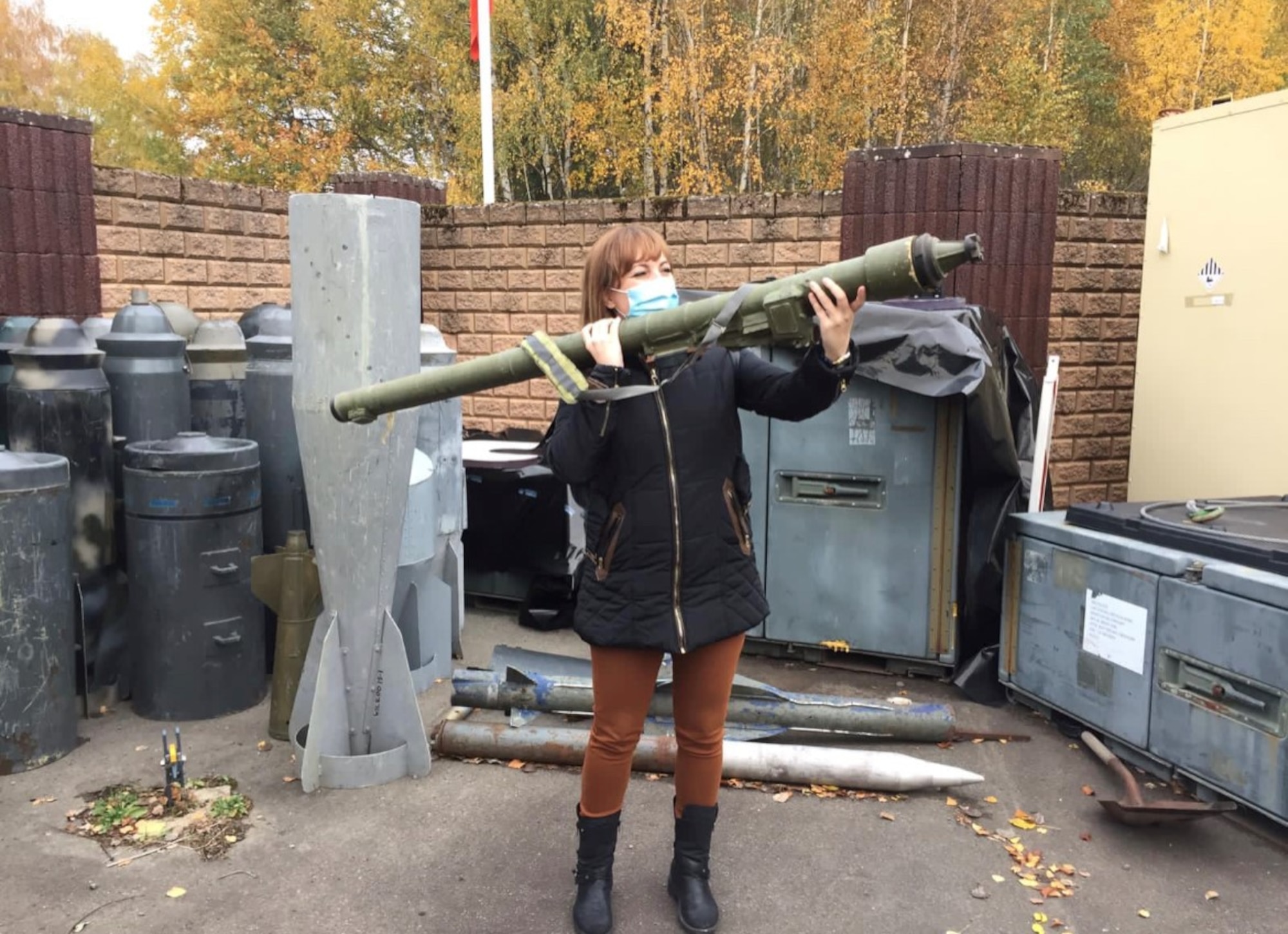 Erica Vega, communication strategist for U.S. Air Forces in Europe and Air Forces Africa Public Affairs, interacts with an inert weapon while touring the 786th Civil Engineer Squadron Explosive Ordnance Disposal Flight at Ramstein Air Base, Germany, November 3, 2020.