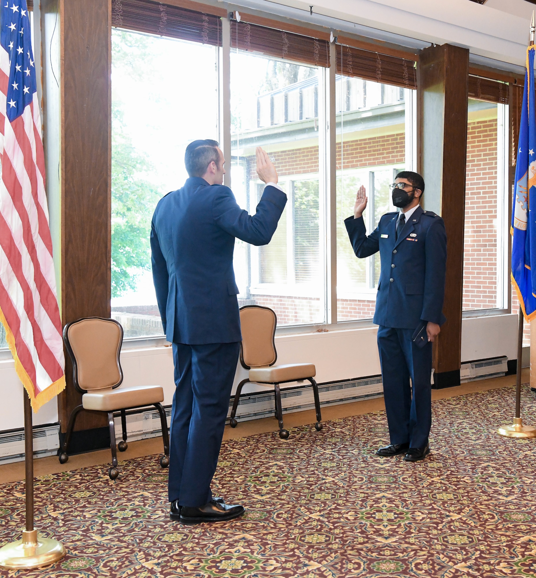Lt. Col. Lane Haubelt, chief of the Arnold Engineering Development Complex Propulsion Test Branch, left, administers the oath of office to newly-promoted 1st Lt. Gregory Landrum during a promotion ceremony May 21, 2021, at Arnold Air Force Base, Tenn. (U.S. Air Force photo by Jill Pickett)