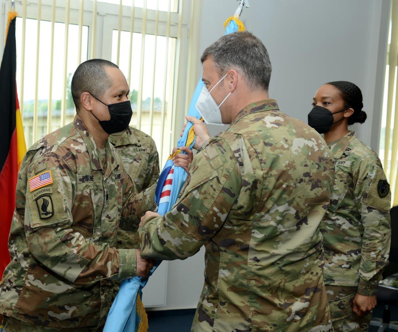 military officers execute a flag passing ceremony