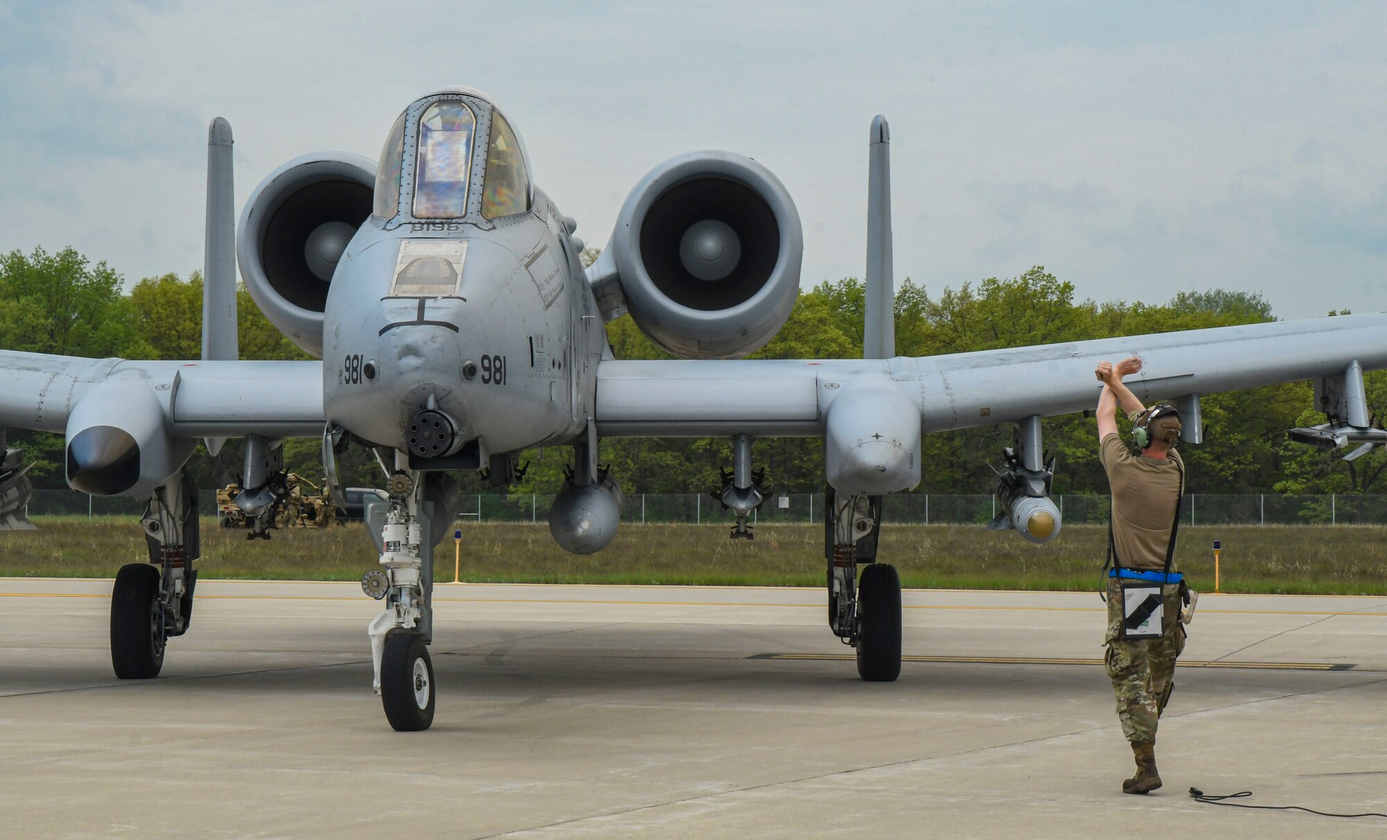 An Airman from the 354th Fighter Squadron signals a U.S. Air Force A-10 Thunderbolt II to halt