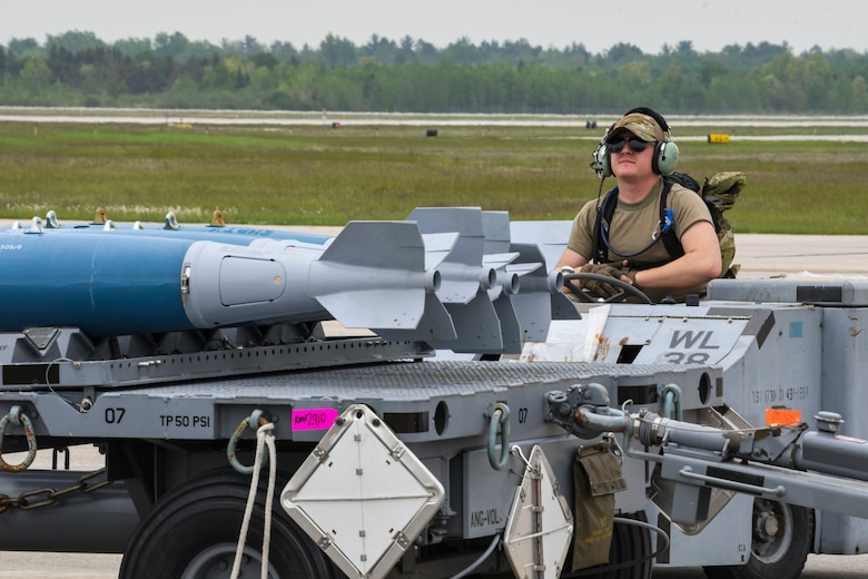 An Airman from the 354th Aircraft Maintenance Unit drives a MHU-83 Bomb Lift