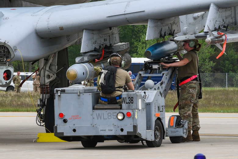 Airmen from the 354th Aircraft Maintenance Unit load a munition to a U.S. Air Force A-10 Thunderbolt II