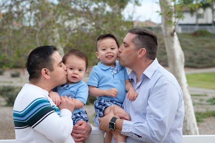 Brady McCarron, a civilian public affairs specialist assigned to Joint Base Anacostia-Bolling, Washington D.C., poses for a family portrait with his husband, Alex, and their two sons, Austin and Connor. McCarron served as a public affairs Airman until his retirement in 2007. (Courtesy photo)