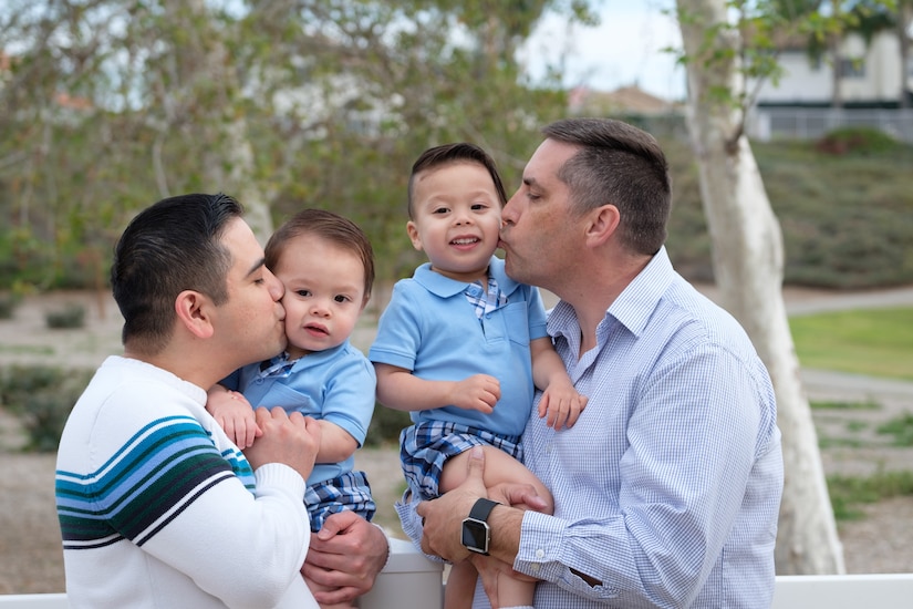 Brady McCarron, a civilian public affairs specialist assigned to Joint Base Anacostia-Bolling, Washington D.C., poses for a family portrait with his husband, Alex, and their two sons, Austin and Connor. McCarron served as a public affairs Airman until his retirement in 2007. (Courtesy photo)