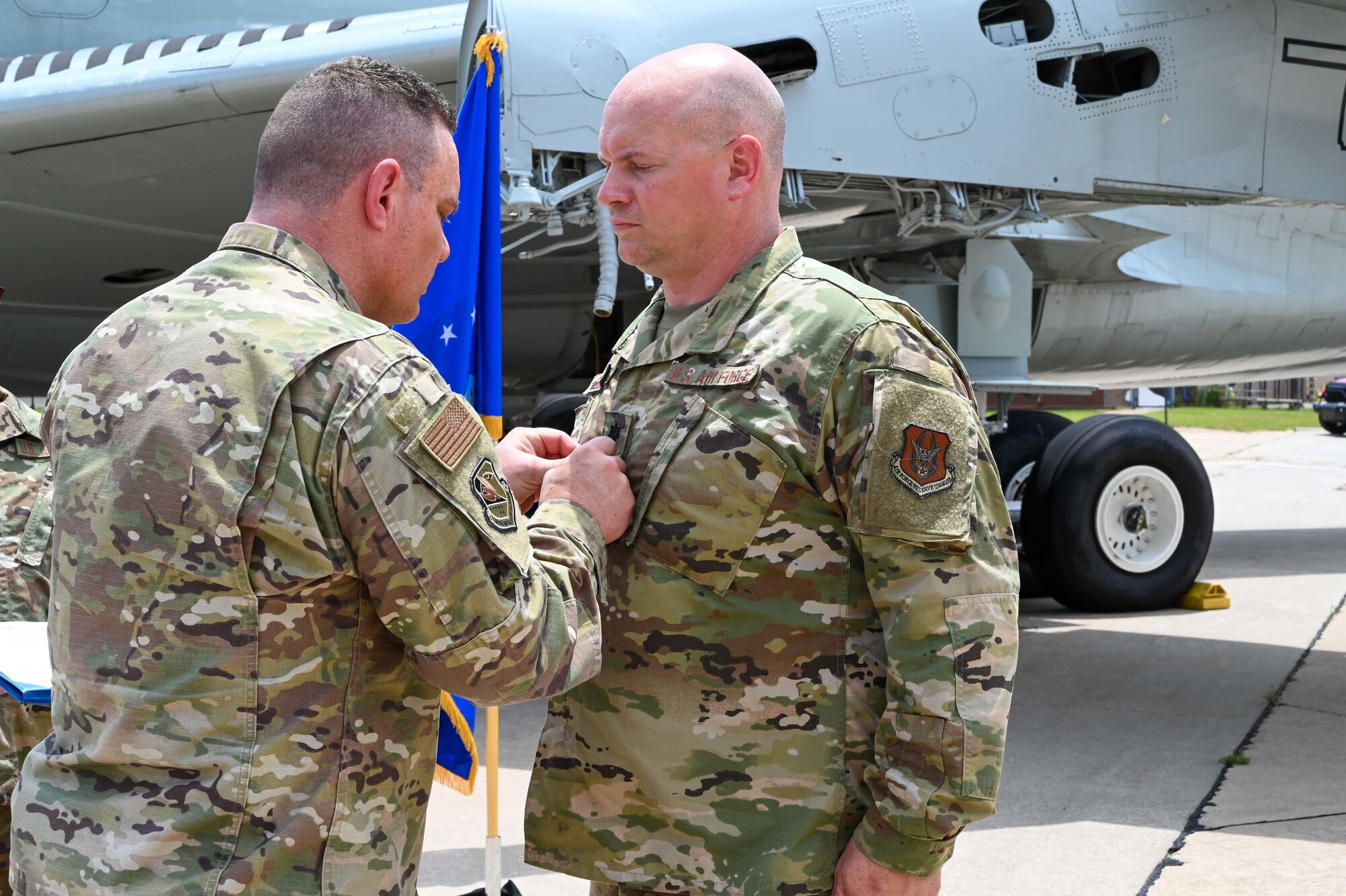 Lt. Col. Stan Young, 507th Mission Support Group commander, presents Lt. Col. Dustin Born, 507th Civil Engineer Squadron former commander, a meritorious service medal during an outdoor change of command ceremony on the flightline June 6, 2021, at Tinker Air Force Base, Oklahoma. (U.S. Air Force photo by Senior Airman Mary Begy)