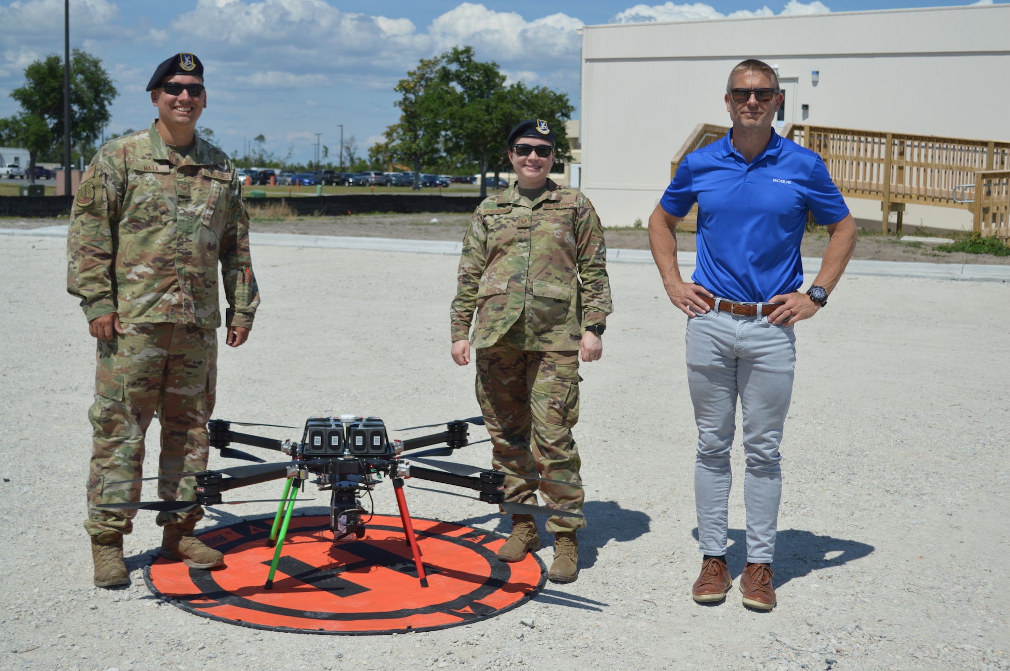 Members of the 325th Security Forces Squadron and Tyndall Program Management Office integration chief, Lowell Usrey, pose by a drone at Tyndall Air Force Base, Florida, June 4, 2021. The drone captured data for a Digital Twin replica of the installation. (U.S. Air Force photo by Sarah McNair)