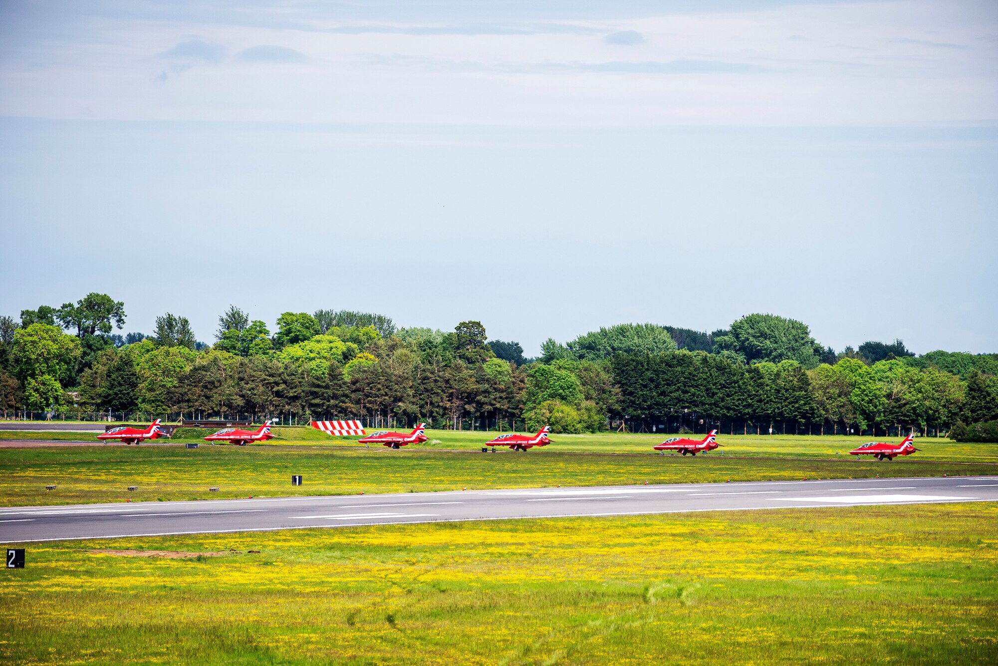 The Royal Air Force aerobatic team, known as the Red Arrows, taxi on the runway at RAF Fairford, England, June 4, 2021. The Red Arrows landed at Fairford to refuel in preparation for the Midlands Air Festival. (U.S. Air Force photo by Senior Airman Eugene Oliver)
