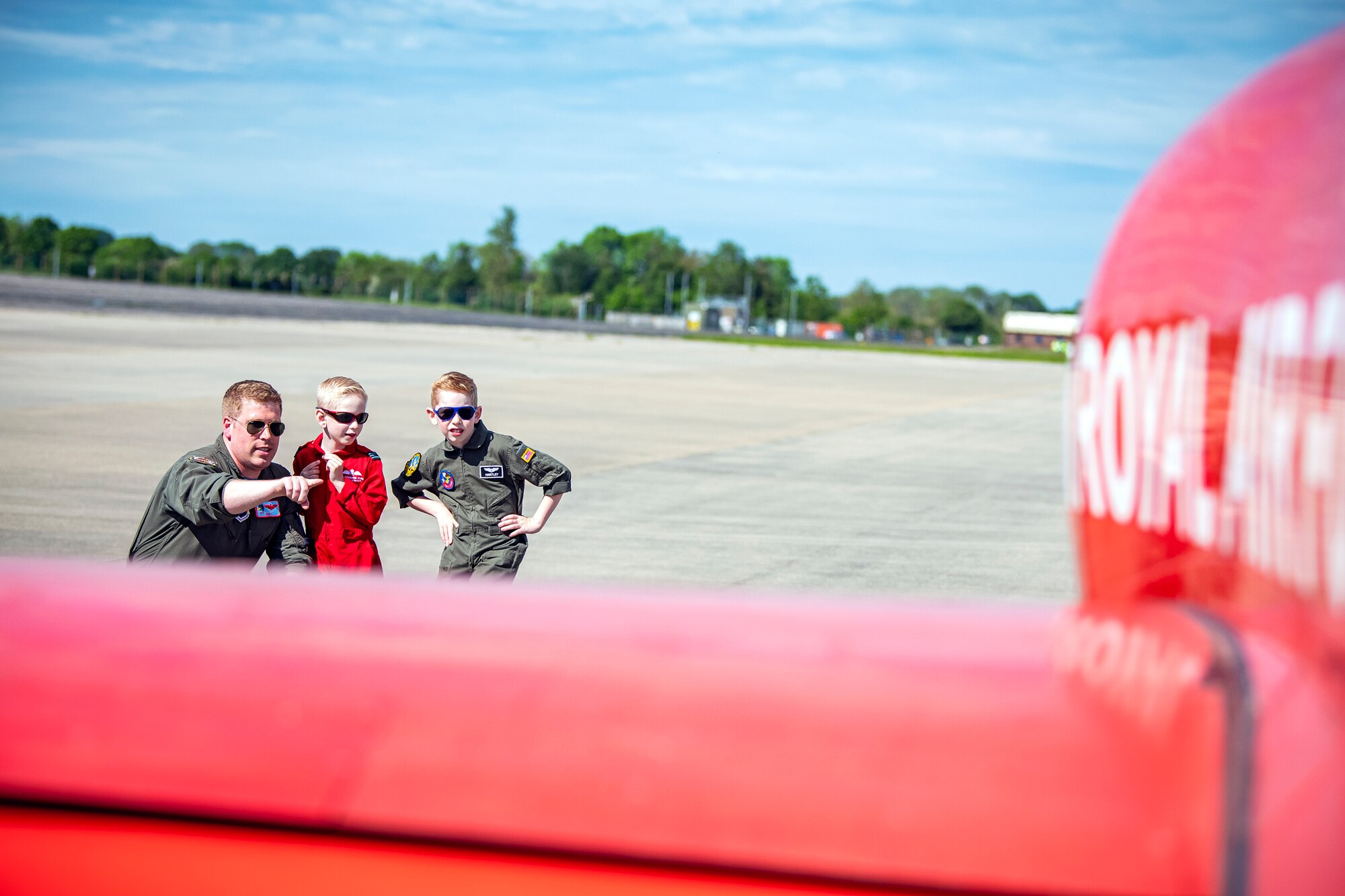 Maj. Joseph Raisner, left, 99th Expeditionary Reconnaissance Squadron director of operations, observes a Hawk T1 aircraft assigned to the Royal Air Force aerobatic team, known as the Red Arrows at RAF Fairford, England, June 4, 2021. The Red Arrows landed at Fairford to refuel in preparation for the Midlands Air Festival. (U.S. Air Force photo by Senior Airman Eugene Oliver)