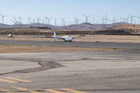 Glider being towed by a plane.