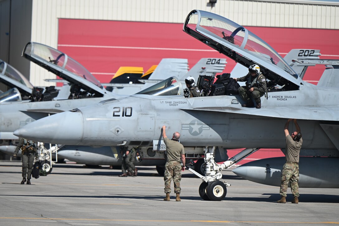 119th Aircraft Maintenance Squadron members receive VFA F/A-18 Super Hornets from Naval Air Station Oceana, Va., as the aircraft arrive to participate in Exercise Victory Hooligan at the North Dakota Air National Guard Base, Fargo, N.D., June 7, 2021. (U.S. Air National Guard photo by Chief Master Sgt. David H Lipp)
