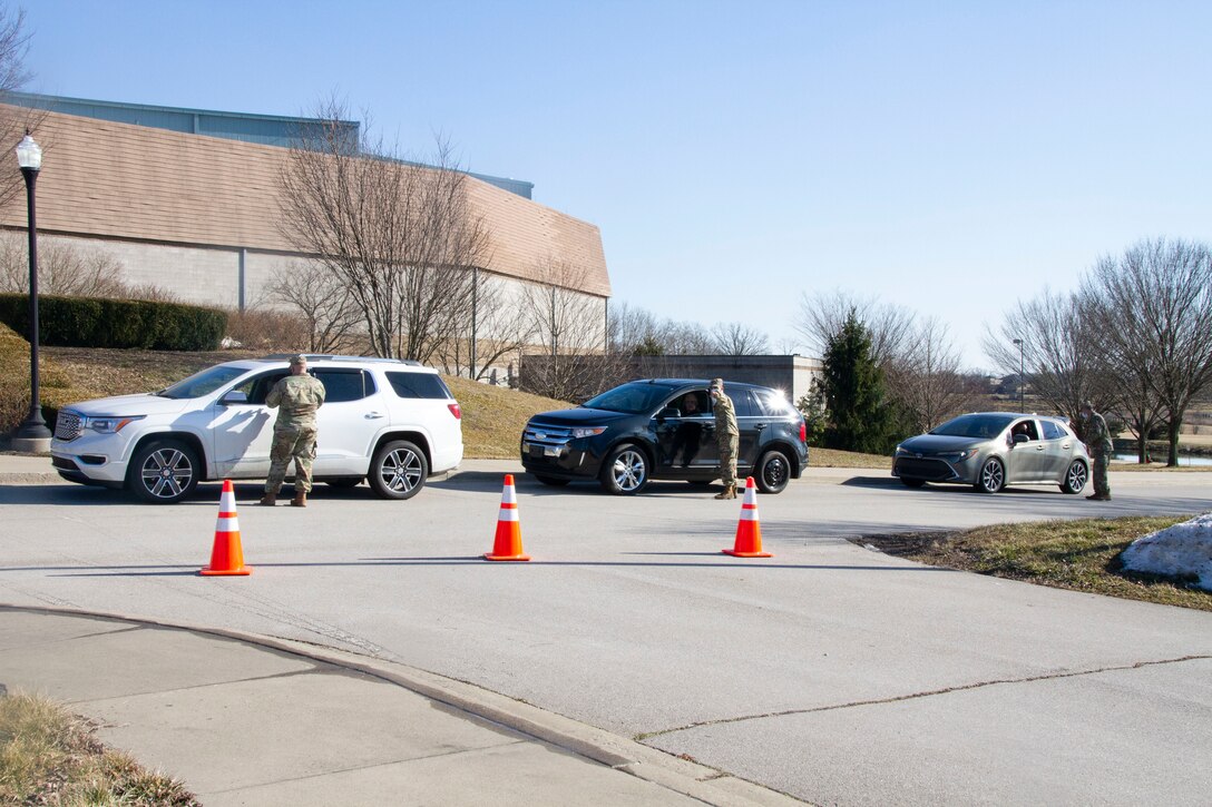 Kentucky National Guard Soldiers conduct traffic control while assisting Kentucky residents at the Kentucky Horse Park COVID-19 vaccine distribution site in Lexington, Ky., April 25. The KYNG partnered with Kroger, Kentucky Emergency Management, and other state agencies to support seven mass vaccination sites across the state.