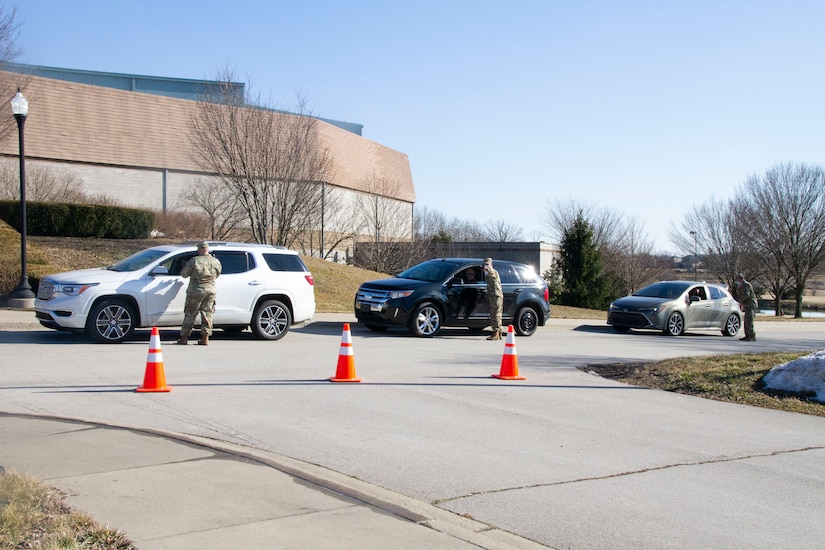 Kentucky National Guard Soldiers conduct traffic control while assisting Kentucky residents at the Kentucky Horse Park COVID-19 vaccine distribution site in Lexington, Ky., April 25. The KYNG partnered with Kroger, Kentucky Emergency Management, and other state agencies to support seven mass vaccination sites across the state.