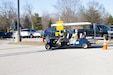 A Kentucky National Guard Soldier transports a Kentucky resident while supporting the Kentucky Horse Park COVID-19 vaccine distribution site in Lexington, Ky., April 25. The KYNG partnered with Kroger, Kentucky Emergency Management, and other state agencies to support seven mass vaccination sites across the state.