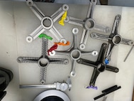 Teams from across the Navy enterprise, as well as those in the public and private sectors, participated in HACKtheMACHINE, a competition to tackle challenges in maritime cybersecurity, data science, and additive manufacturing (AM) over the course of four days. As part of Track 3, entitled, “Heavy Metal,” teams developed a technical design package (TDP) and 3-D printed their designed bracket that would connect a light fixture to a light stanchion.