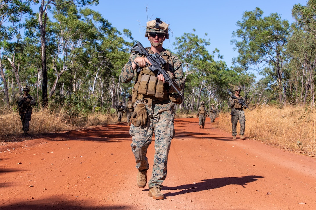 U.S. Marine Corps Cpl. Dalton Boswell, a team leader with Alpha Battery, 2nd Low Altitude Air Defense Platoon, Aviation Combat Element, Marine Rotational Force - Darwin, walks in formation during ground threat reaction drills at Mount Bundy Training Area, NT, Australia, May 28, 2021. Alpha Battery conducted tactical training during a three-day field evolution. 2nd LAAD is an air defense unit that is capable of providing early warning of hostile air threats to other elements of the air defense system.