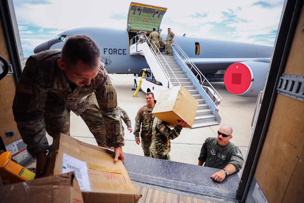 Soldiers load boxes of medical supplies.