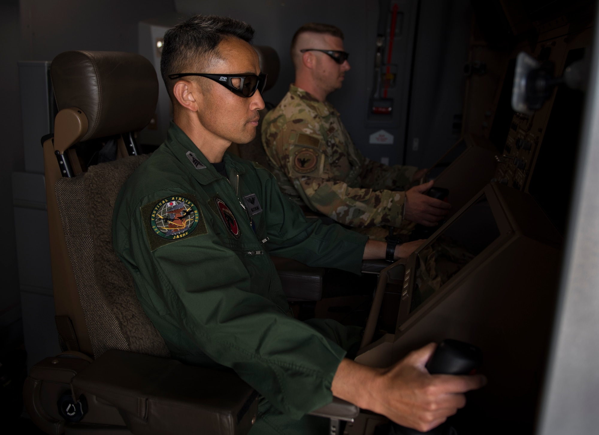 Japan Air Self-Defense Force Chief Master Sgt. Teruyuki Mizokami, 405th Air Refueling Squadron senior boom-operator, simulates operating a KC-46 Pegasus boom, May 13, 2021, at Altus Air Force Base, Oklahoma. The KC-46 boom operator is seated in the front of the aircraft while operating the boom instead of in the back as with other refuelers, such as the KC-135 and KC-10. (U.S. Air Force photo by Airman 1st Class Amanda Lovelace)