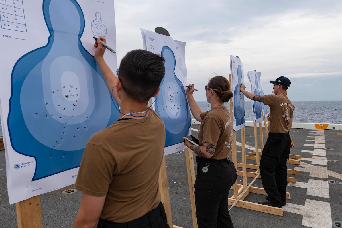 Sailors write on shooting targets.