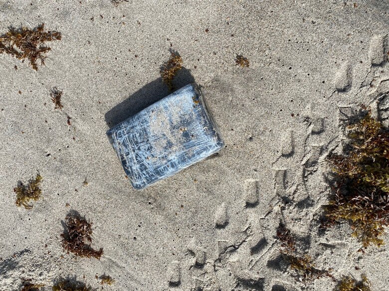 Defenders from the 45th Security Forces Squadron seize nearly 30 kilograms of cocaine that washed ashore on a Cape Canaveral Space Force Station, Florida, beach, May 19, 2021. According to the Brevard County Sheriff's Office, the drugs had an estimated value of approximately $1.2 million.