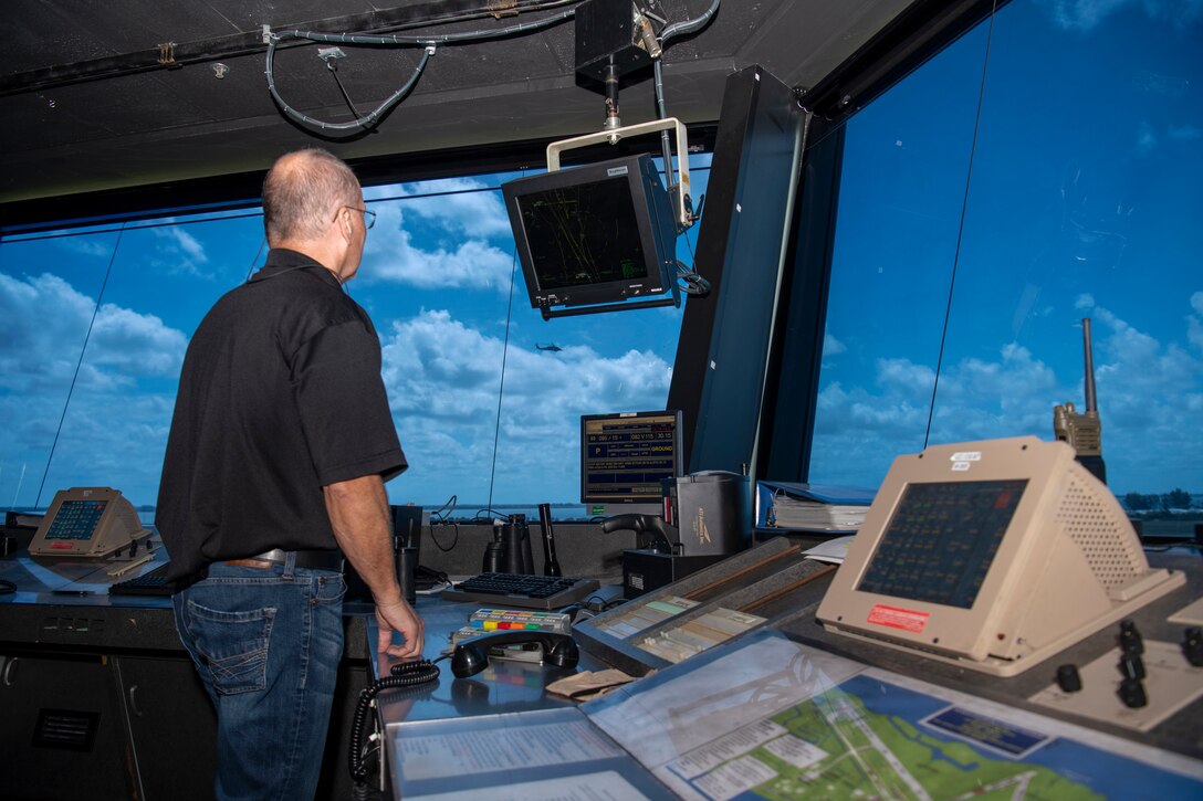 Donald Beckwith, 45th Logistics Readiness Squadron lead air traffic controller, watches a UH-60 Black Hawk helicopter fly over the airfield from inside the Patrick Space Force Base, Fla., tower May 18, 2021. Beckwith led operations in the tower April 17 when a TBM Avenger made an emergency water landing near Patrick SFB. (U.S. Space Force photo by Tech. Sgt. James Hodgman)