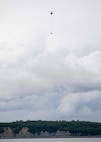 A 1st Battalion, 207th Aviation Regiment CH-47 Chinook helicopter with a Bambi water bucket system attached flies overhead during the unit's Red Card certification on Joint Base Elmendorf-Richardson, June 9, 2021. Red Card certification, also known as the Incident Qualification Card, is an accepted interagency certification that a person is qualified in order to accomplish the required mission when arriving on an incident. For 1-207th AVN pilots, this certification means proficiency in water bucket drops to assist with wildfire emergencies within the state. (U.S. Army National Guard photo by Spc. Grace Nechanicky)