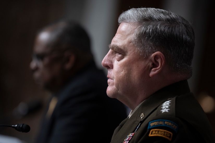 Secretary of Defense Lloyd J. Austin III and Army Gen. Mark A. Milley sit at a table.