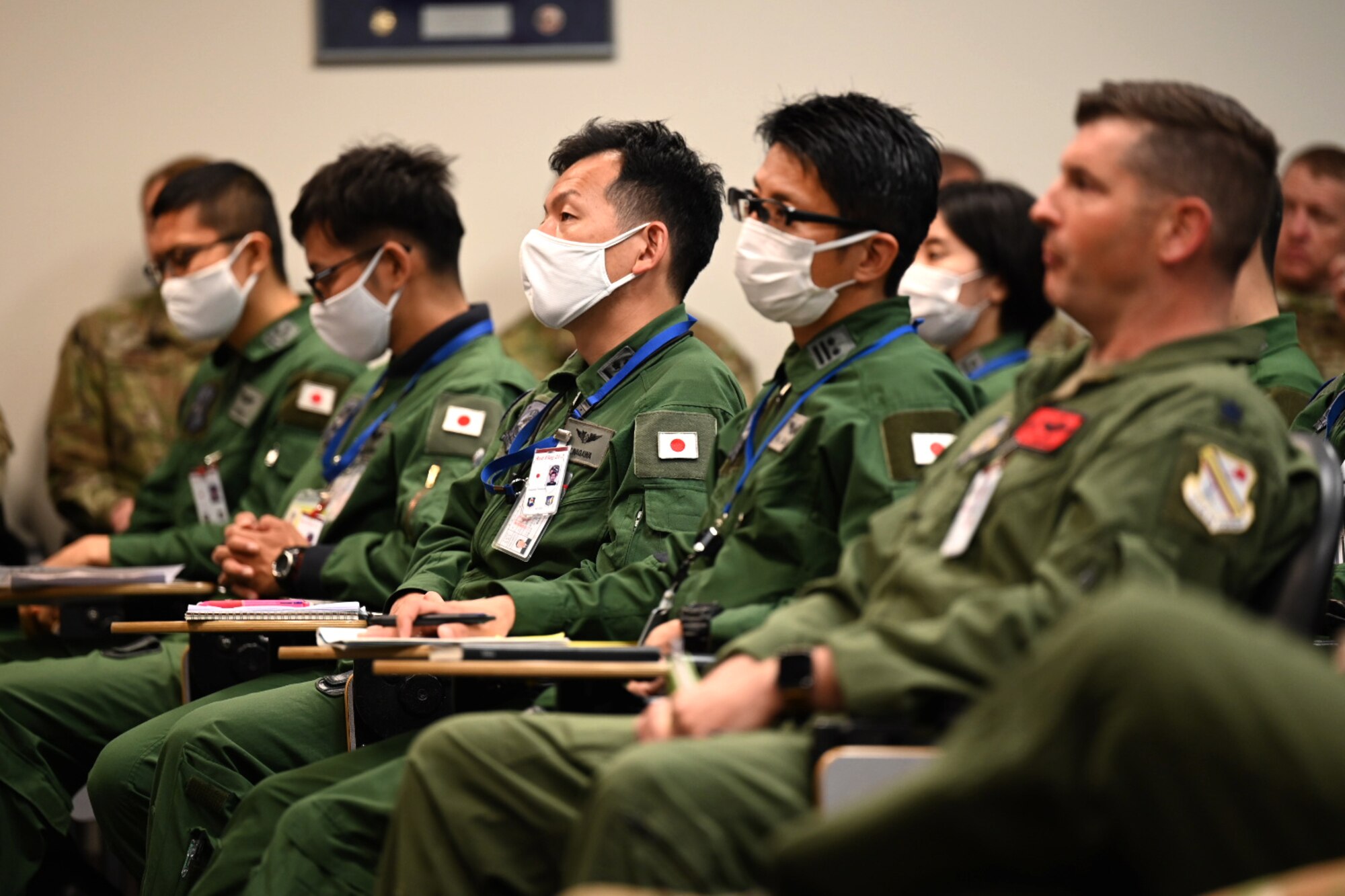 Service members from U.S. Air Force and Japan Self-Air Defense Force listen to the Deployed Forces Commander, Col. Brian Cusson, to kick-off RED FLAG-Alaska 21-2 at Joint Base Elmendorf-Richardson, Alaska, June 10, 2021.