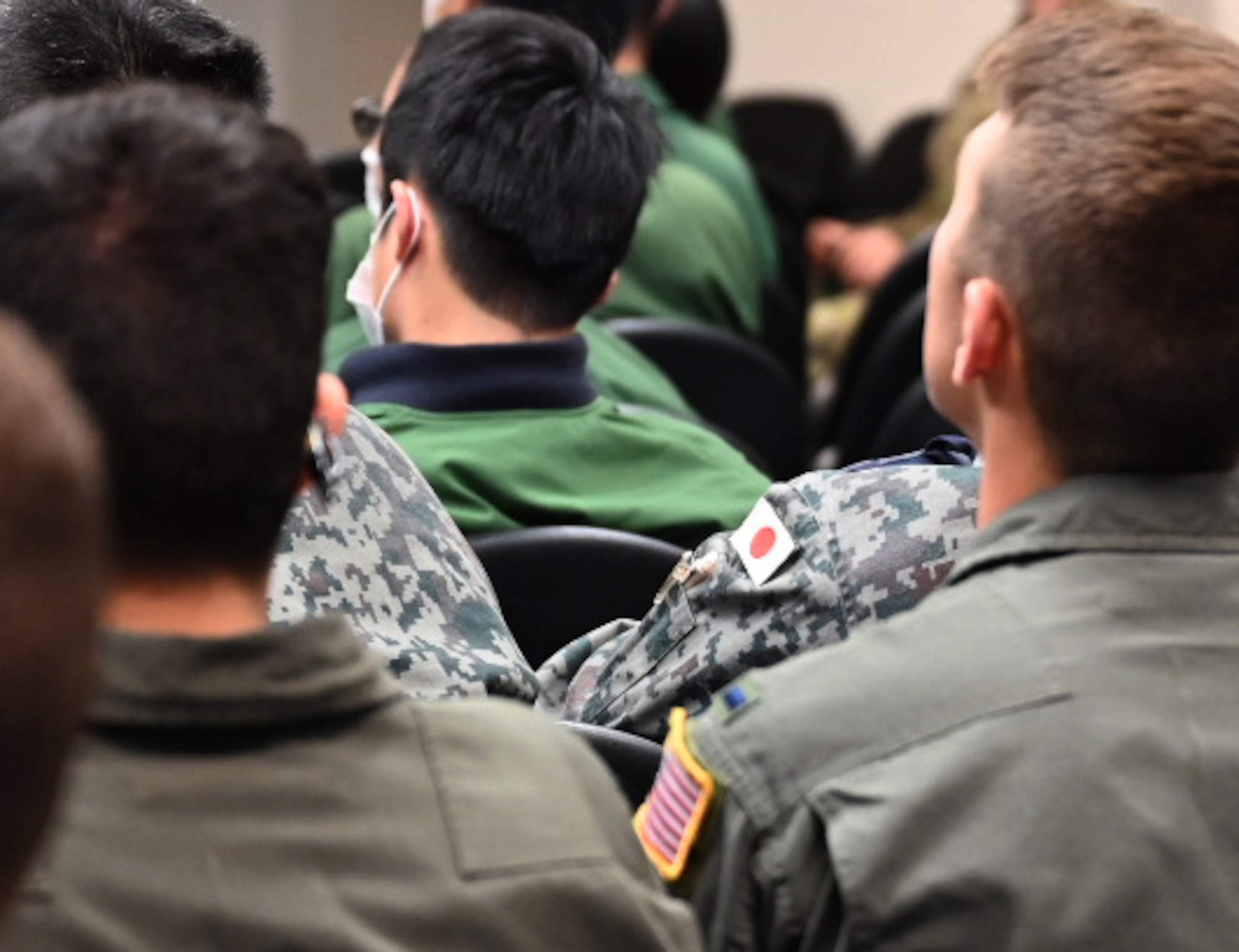 Service members from U.S. Air Force and Japan Self-Air Defense Force listen to the Deployed Forces Commander, Col. Brian Cusson, to kick-off RED FLAG-Alaska 21-2 at Joint Base Elmendorf-Richardson, Alaska, June 10, 2021.