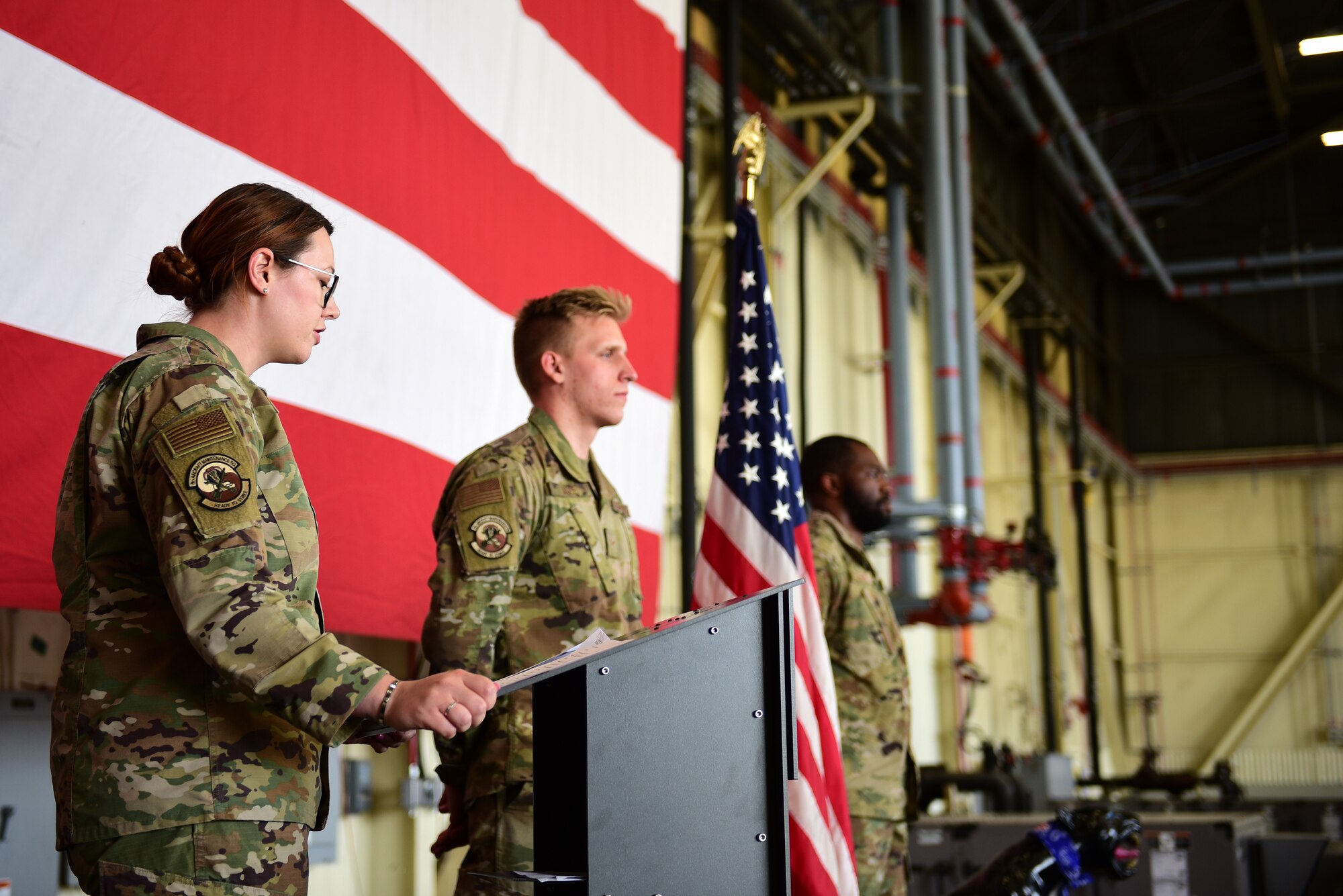 Capt. Christina Nunley, 35th Aircraft Maintenance Unit officer in charge, emcees the Dedicated Crew Chief ceremony at Kunsan Air Base, Republic of Korea, May 24, 2021. The DCC program is a well-established tradition and privilege granted to highly skilled maintainers who are responsible for aircraft health. (U.S. Air Force photo by Senior Airman Suzie Plotnikov)
