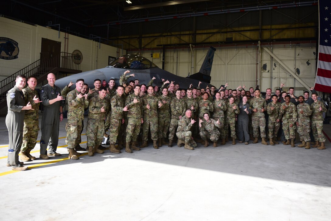 Eighth Fighter Wing leadership and 35th Aircraft Maintenance Unit Airmen pose for a photo during the Dedicated Crew Chief ceremony at Kunsan Air Base, Republic of Korea, May 24, 2021. The ceremony recognizes DCCs, also known as highly skilled tactical aircraft maintainers, as their names are displayed on the aircraft to show their dedication and commitment. (U.S. Air Force photo by Senior Airman Suzie Plotnikov)