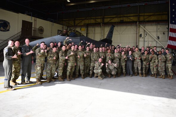 Eighth Fighter Wing leadership and 35th Aircraft Maintenance Unit Airmen pose for a photo during the Dedicated Crew Chief ceremony at Kunsan Air Base, Republic of Korea, May 24, 2021. The ceremony recognizes DCCs, also known as highly skilled tactical aircraft maintainers, as their names are displayed on the aircraft to show their dedication and commitment. (U.S. Air Force photo by Senior Airman Suzie Plotnikov)
