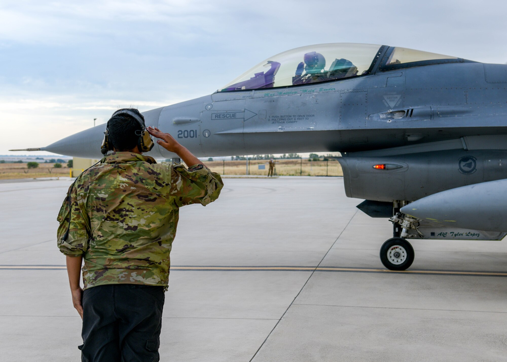 Airman 1st Class Abdiel Hilerio Arvelo, 555th Fighter Squadron F-16 Fighting Falcon crew chief, salutes a U.S. Air Force F-16 pilot during Falcon Strike 21 (FS21) at Amendola Air Base, Italy, June 7, 2021. FS21 is a joint, multinational exercise designed to provide aircrew training through fourth-and-fifth-generation integration. (U.S. Air Force photo by Airman 1st Class Brooke Moeder)