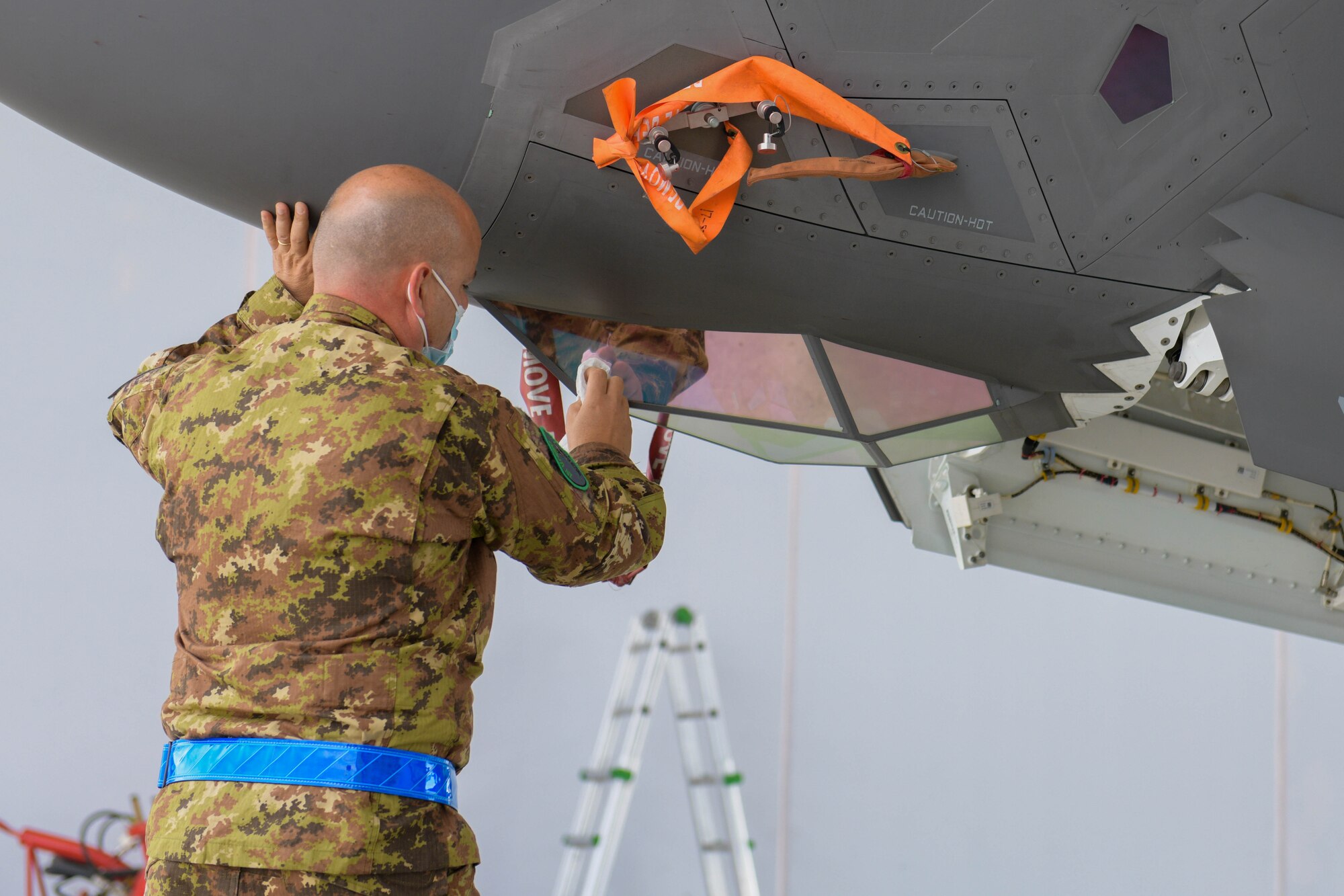 Italian air force Lt. Sebastiano Fattizzo, 13th Group F-35 Lightning II crew chief, performs cross servicing maintenance on a U.S. Air Force F-35 from the 4th Fighter Squadron, 388th Fighter Wing, during Falcon Strike 21 (FS21) at Amendola Air Base, Italy, June 7, 2021. Approximately 600 personnel from the U.S. Air Force, U.S. Marine Corps, Italian air force, Israeli air force and the United Kingdom Royal air force are participating in FS21. (U.S. Air Force photo by Airman 1st Class Brooke Moeder)
