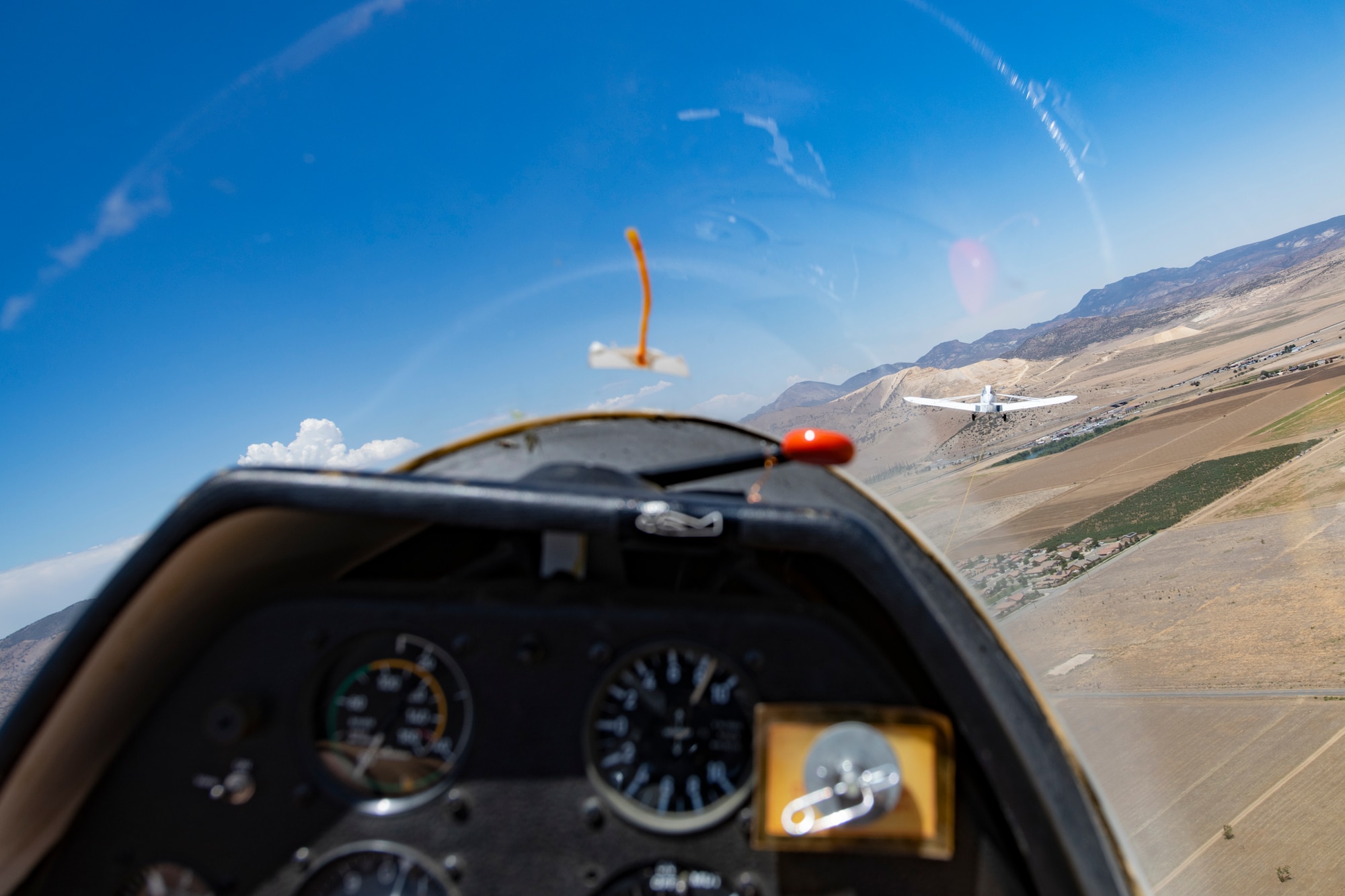 Glider being towed by a plane.